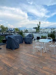 a patio with a table and chairs on a balcony at Departamento en lomas de angelopolis, Isla blanca in Lomas de Angelopolis