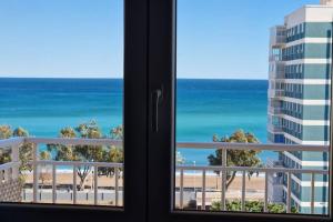 a view of the beach from a window at Stunning sea vistas by the beach in Benicàssim
