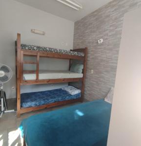 a room with two bunk beds and a blue rug at Vila do Chaves bed breakfast in Sao Paulo +7 photos