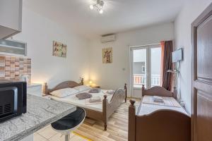 Posteľ alebo postele v izbe v ubytovaní Studio Apartmani Ivanda