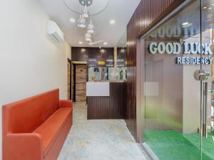 a lobby with a orange couch and a good luck restaurant at Hotel Good Luck Residency- Near Nesco in Mumbai