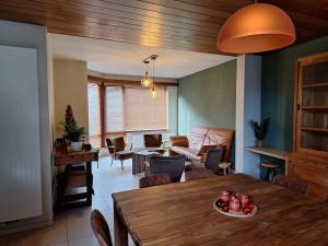 a living room with a table and a dining room at Vakantiehuis Latfin in Middelkerke