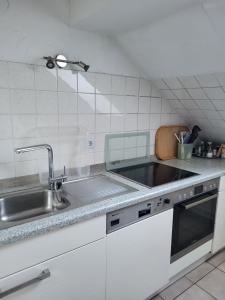 a kitchen with a sink and a counter top at Ferienwohnung in Hövelhof