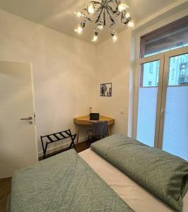 a bedroom with a bed and a desk with a laptop at Stadt-Idyll Schwerin im Zentrum in Schwerin +19 photos