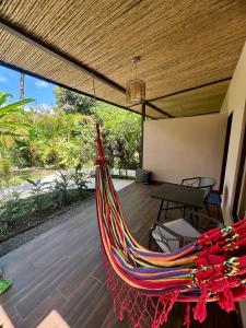 a hammock on the porch of a house at Villa Tucan in Fortuna