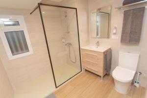 a bathroom with a shower and a toilet and a sink at BatFlats - RUZAFA in Valencia +20 photos