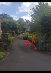 a car driving down a driveway with at 25 Glenfell Place - One Bedroom Studio in Auckland