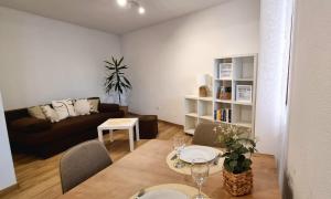 a living room with a couch and a table and chairs at Accommodation Huljić in Hvar