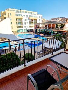 a balcony with a view of a swimming pool at Pool View Apartment, Sunny Beach Resort in Sunny Beach