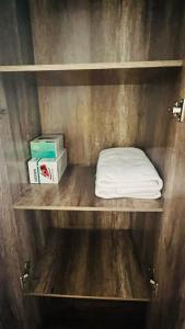a shelf with a white pillow and boxes on it at Apartamentos Cerro Blanco in Santiago