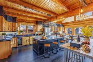 a large kitchen with a large center island with bar stools at Luxury Family Cabin at Summit West in Snoqualmie Pass