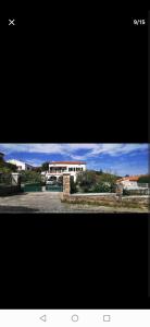 two pictures of a house and a building at Appartement entre mer et montagne avec beau jardin in Calenzana