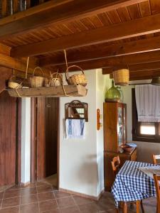 a room with a table and baskets on the ceiling at Κτήμα Κουρλή in Tavari +46 photos
