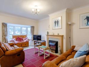 a living room with a couch and a fireplace at 3 Bed in Brixham BX002 in Brixham