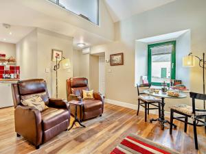 a living room with leather chairs and a table at 1 Bed in Dunning CA333 in Dunning