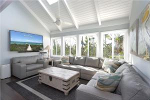 a living room with a couch and a table at Sealoft Village #105 - Come stay on Sanibel! in Sanibel