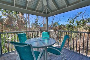 a patio with a table and chairs on a balcony at Sealoft Village #105 - Come stay on Sanibel! in Sanibel