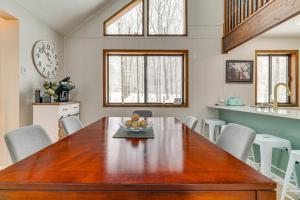 a kitchen and dining room with a wooden table and chairs at Family-Friendly Big Bass Lake Vacation Rental! in Gouldsboro