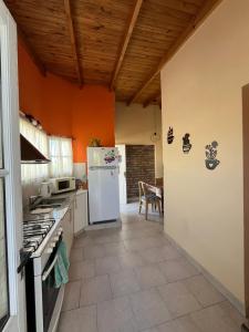 a kitchen with a white refrigerator and a table at Departamento Centro RIOyMAR in Viedma