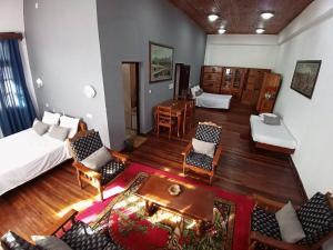 a room with a bed and a table and chairs at Hôtel Diamant Antsirabe in Antsirabe