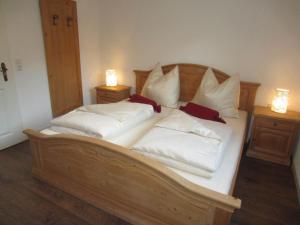 a bedroom with two beds with white pillows at Heidi's Schlummerkiste in Breitenau am Hochlantsch