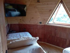 Postelja oz. postelje v sobi nastanitve Domos Arcoiris de Chiloé