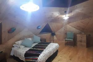 Postelja oz. postelje v sobi nastanitve Domos Arcoiris de Chiloé