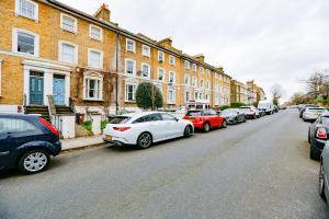 a row of cars parked on the side of a street at Gorgeous 1 Bedroom Property in London