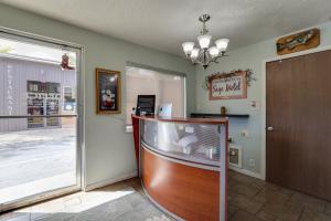 a lobby with a glass door and a fish tank at Sage Motel in Vernal