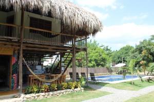 a resort with a swimming pool and a building at Bao Bao Hostel in Palomino