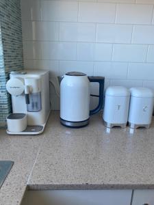 a kitchen counter with two coffee machines on it at Guesthouse, read about the host before booking please in Wollongong