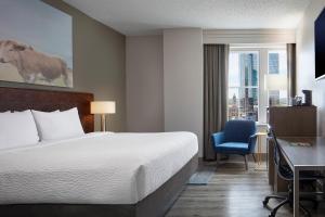 una camera d'albergo con letto, scrivania e finestra di Courtyard Fort Worth Downtown/Blackstone a Fort Worth