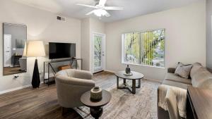 a living room with a couch and a tv at Landing - Modern Apartment with Amazing Amenities (ID7762X30) in Leisure World