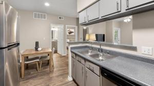 a large kitchen with a sink and a table at Landing - Modern Apartment with Amazing Amenities (ID7762X30) in Leisure World