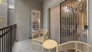a porch with a table and chairs on a balcony at Landing - Modern Apartment with Amazing Amenities (ID7762X30) in Leisure World