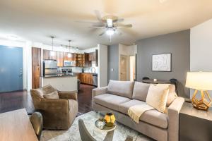 a living room with a couch and a table at Landing - Modern Apartment with Amazing Amenities (ID5045X8) in San Antonio