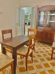 a dining room with a wooden table and chairs at Dimora salenTina in Tricase