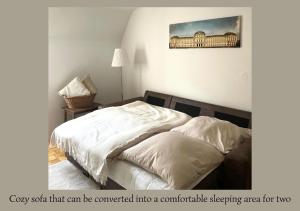 a bedroom with a bed with white sheets at Urban Retreat - Central and Historic with Private Parking in Würzburg