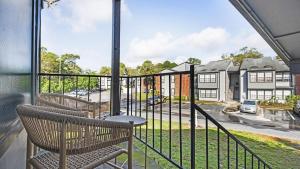 two chairs on a balcony with a view of a building at Landing - Modern Apartment with Amazing Amenities (ID7412X03) in Orlando