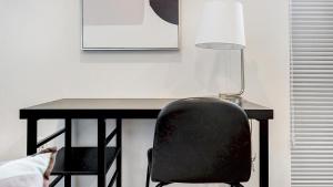 a black desk with a black chair and a lamp at Landing - Modern Apartment with Amazing Amenities (ID7010) in Bala-Cynwyd