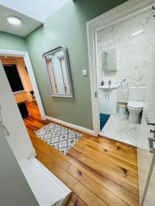 a bathroom with a toilet and a sink at Notting Hill Guest Flat in Ealing