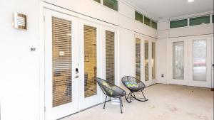 a screened in porch with two chairs and windows at Landing - Modern Apartment with Amazing Amenities (ID6650X47) in Fort Worth
