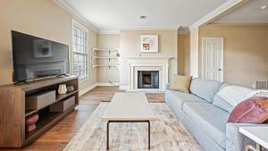 a living room with a couch and a tv at Landing - Modern Apartment with Amazing Amenities (ID7786X36) in Nashville