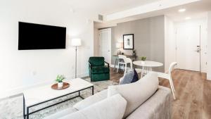 a living room with a couch and a table at Landing - Modern Apartment with Amazing Amenities (ID748) in Fort Lauderdale