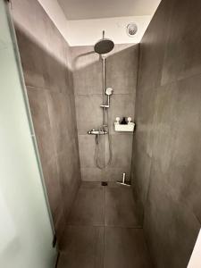 a bathroom with a shower with a shower head at Apartment in Reykjavikurvegur - Birta Rentals in Hafnarfjördur