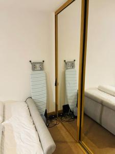 a mirror in a room with a bed at Play Away Lodge in Basildon