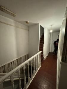a person walking down a staircase in a building at Huddersfield house in Huddersfield