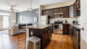 a kitchen with wooden cabinets and stainless steel appliances at Landing - Modern Apartment with Amazing Amenities (ID1179X021) in Wilmington