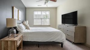 a bedroom with a bed with a television and a dresser at Landing - Modern Apartment with Amazing Amenities (ID1179X021) in Wilmington