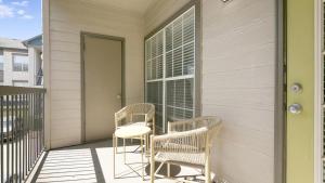 two chairs and a table on a porch at Landing - Modern Apartment with Amazing Amenities (ID1003X719) in Austin